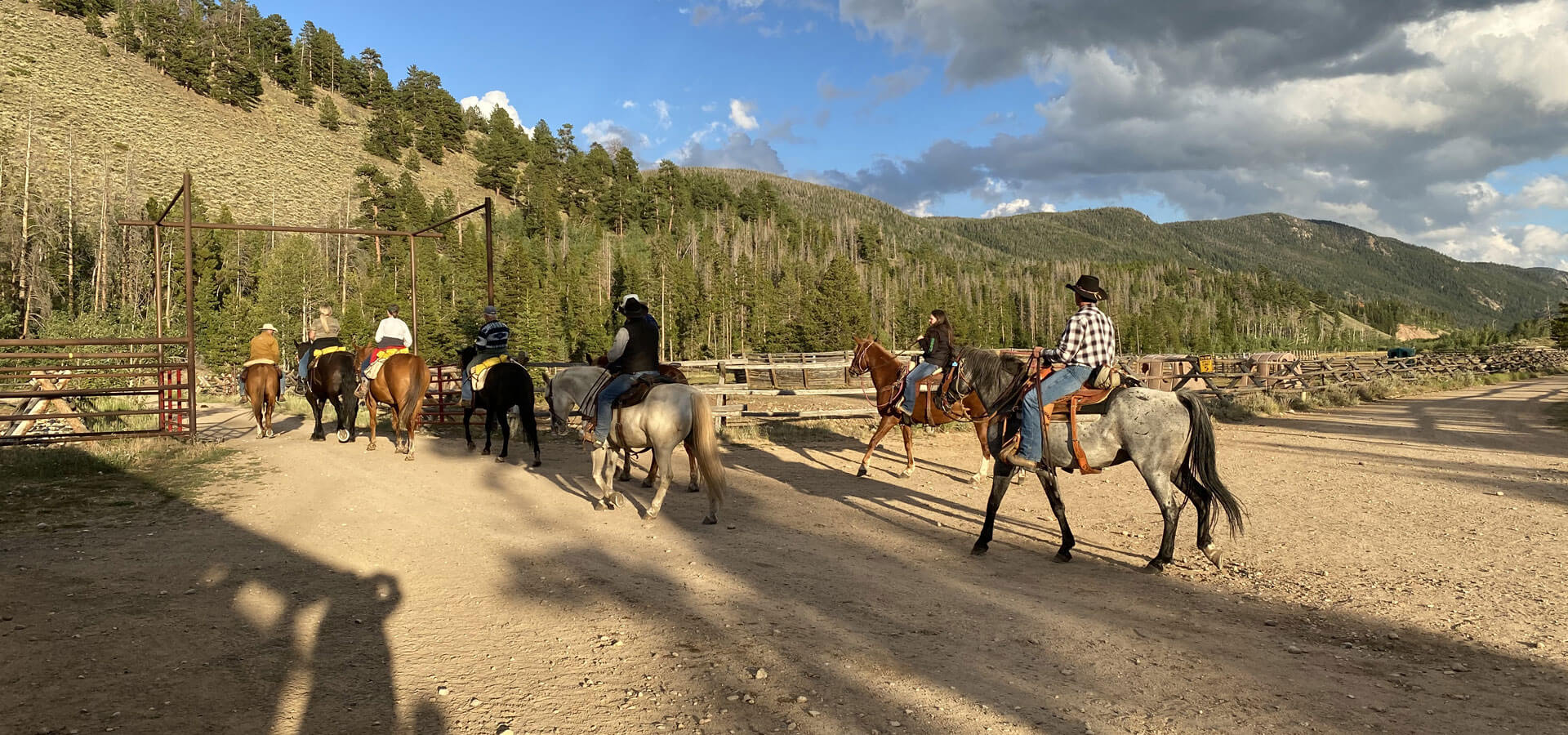 Photo of a group horseback riding during a corporate retreat at Rawah Ranch.