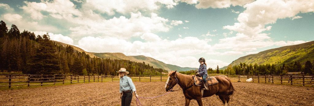 Photo of people horseback riding during a staycation in Colorado
