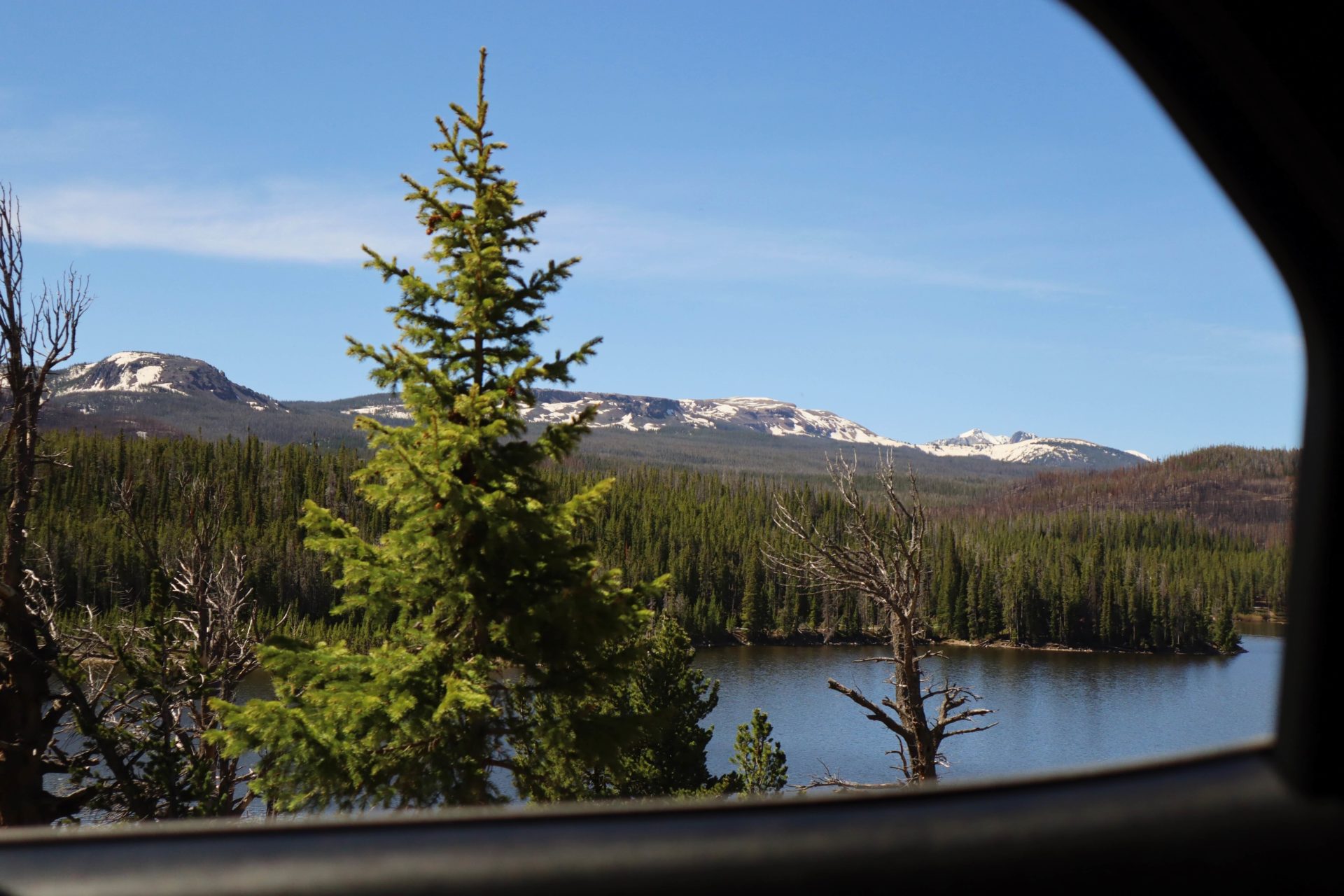 Photo of mountains, water, and trees during a Denver road trip to Rawah Ranch