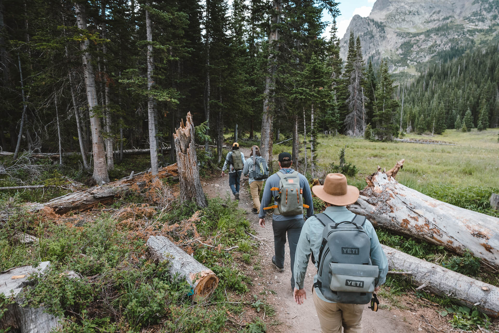 Group of men hiking at Rawah Ranch during an outdoor Colorado bachelor party