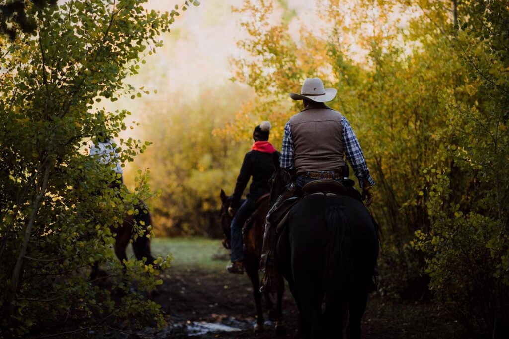 People horseback riding at Rawah Ranch, a guest ranch in Northern Colorado