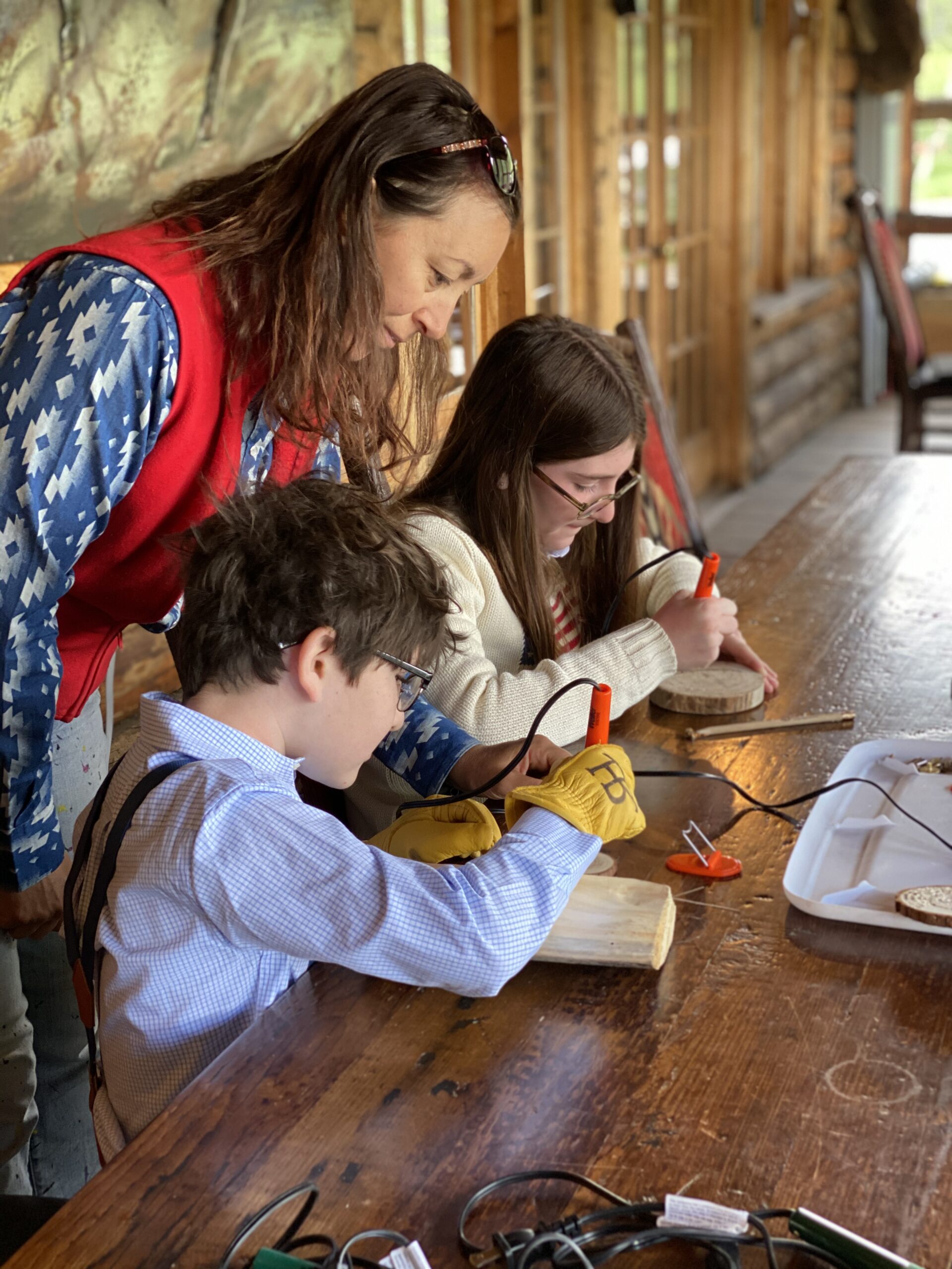 Kids working on craft during a digital detox retreat at Rawah Ranch in Colorado