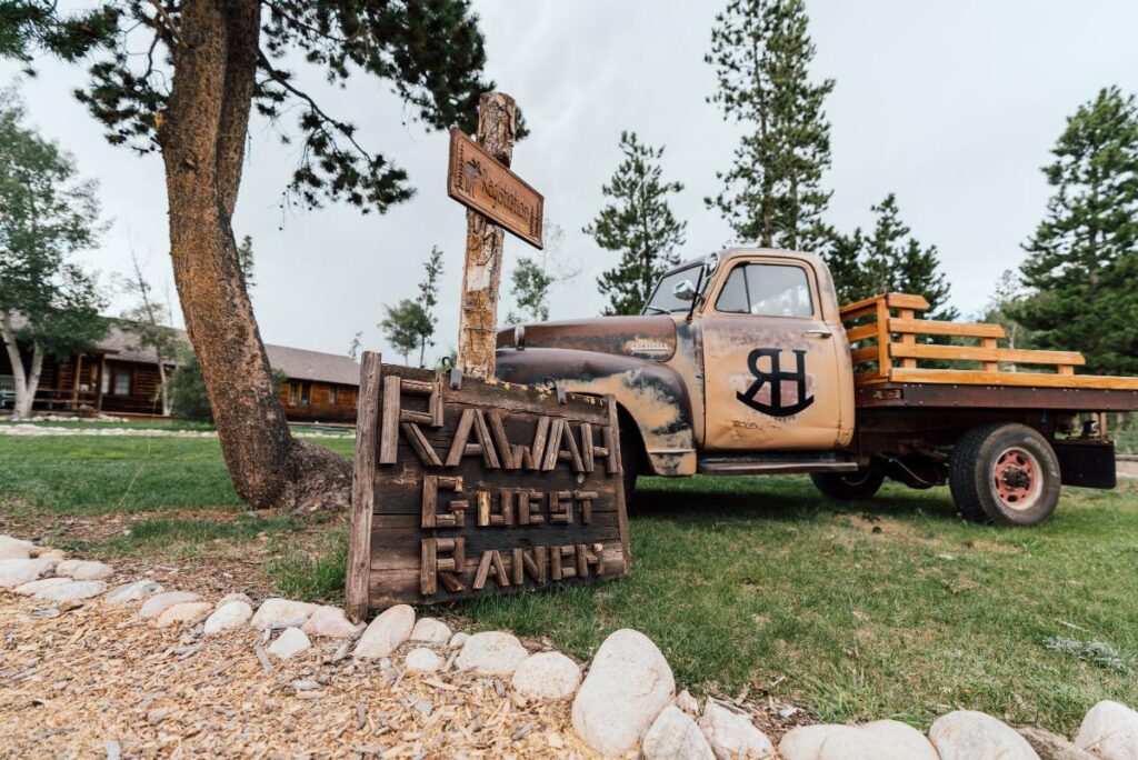 Old truck with vintage Rawah Guest Ranch sign in front